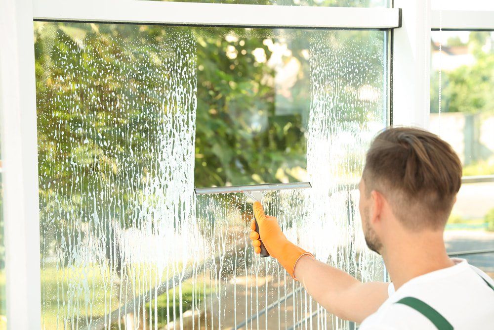 back of head of man cleaning window orig 1000x667 1920w